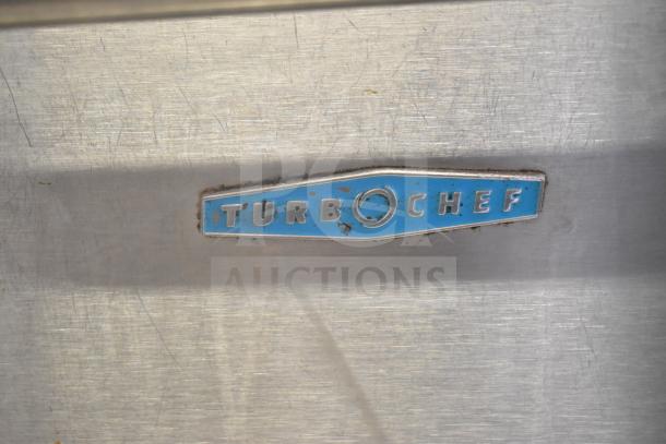 Turbochef NGC Rapid Cook Oven label on stainless steel. Blue logo, slight wear. Electric, 208/230-240 Volts, 1 Phase.