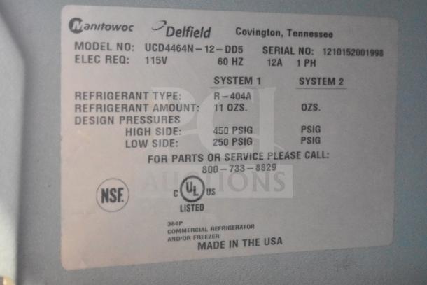 Delfield UCD4464N-12-DD5 sandwich prep table label. Displays model, serial number, voltage, and refrigerant details. Made in USA.