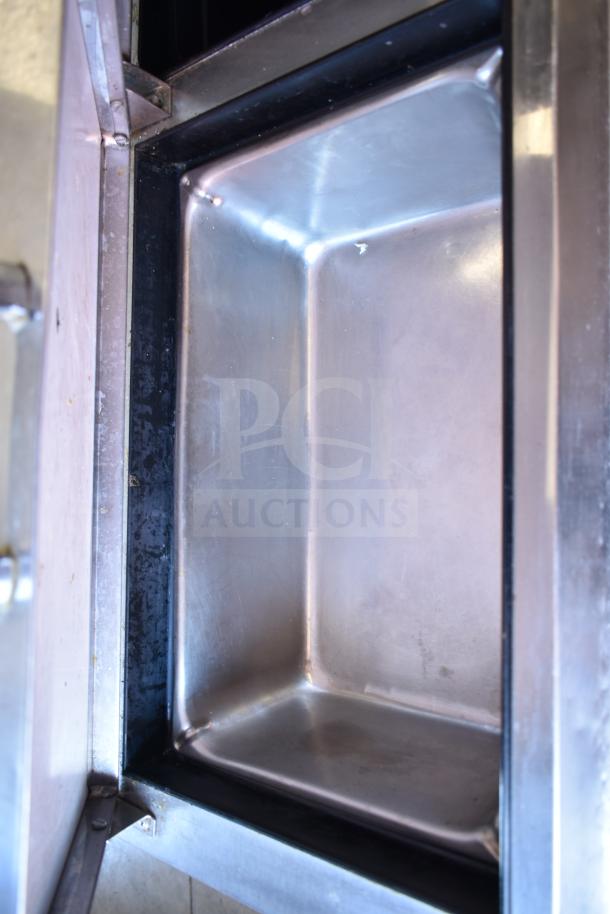 True TPP-93D-6 commercial pizza prep table interior, stainless steel finish, showing clean interior surface.