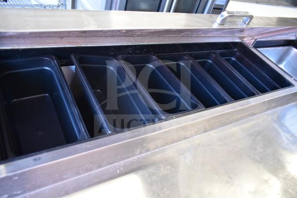 True TPP-93D-6 commercial pizza prep table with 6 drawers and ingredient bins, on commercial casters. 115 volts, 1 phase.