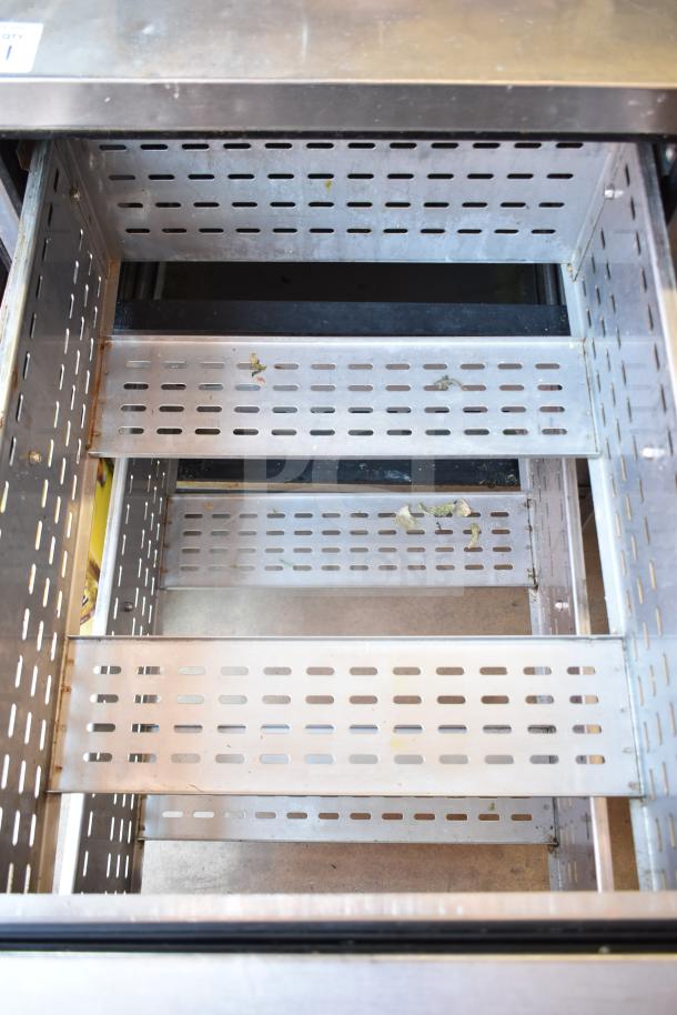True TPP-93D-6 commercial pizza prep table with six drawers on casters, 115 volts, 1 phase, shown with open drawer.