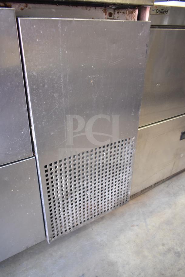 True TPP-93D-6 commercial pizza prep table, featuring 6 drawers and commercial casters, 115 volts, 1 phase. Visible wear on surface.