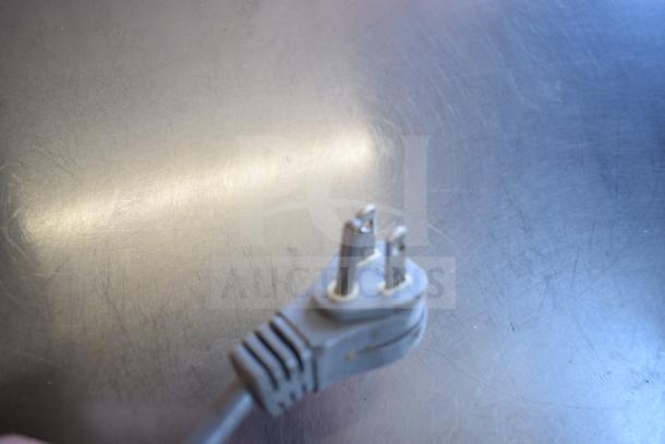 True TPP-93D-6 Pizza Prep Table plug close-up, commercial-grade, 115V, 1 Phase, stainless steel surface visible.