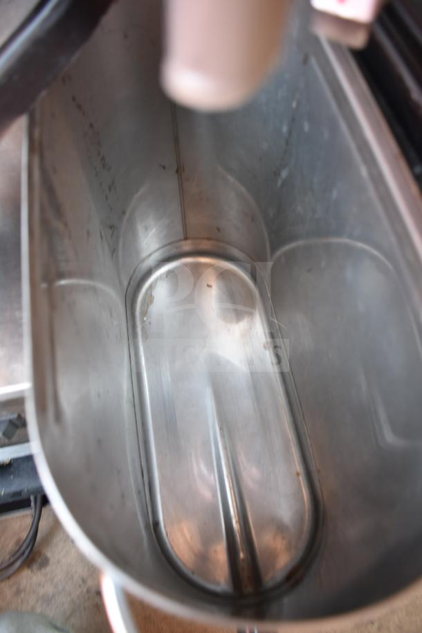 Bunn Commercial Countertop Iced Tea Machine, interior view of stainless steel beverage holder, shows clean surface.