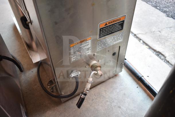 Bunn Commercial Iced Tea Machine with dispenser, 120 volts, 1 phase. Features warning labels and a beverage holder.