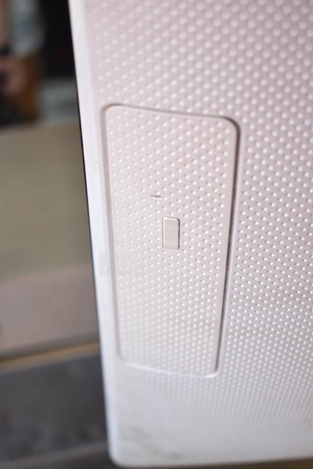 HP All In One Computer, white textured rear panel, minimal wear, close-up view of power button area.