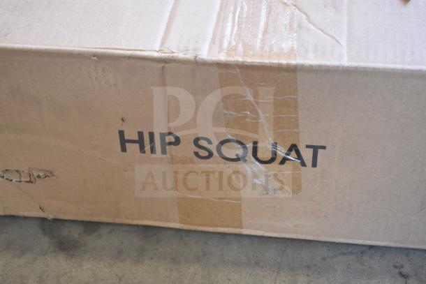 Cardboard box labeled "HIP SQUAT," showing minor scratches and dents, containing a brand new IWHS-201 Hip Squat Machine.