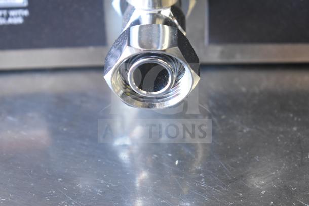 Curtis GEM3IF 1.5 Gallon Coffee Server tap close-up showing polished metal nozzle on stainless steel surface.