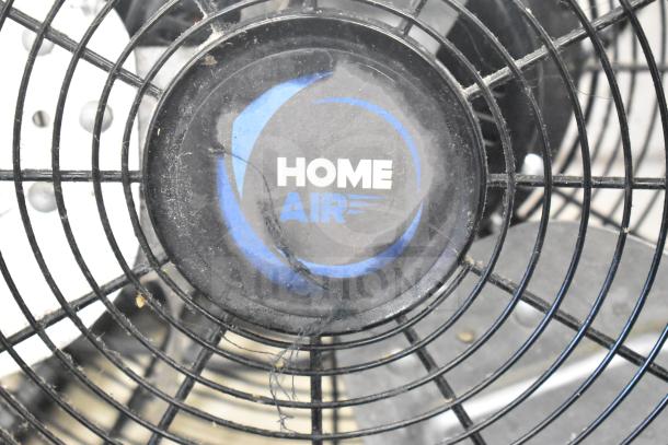 Home Air SZPD-05 fan, black grille, blue logo. 120 volts, single-phase. Visible wear on center emblem.