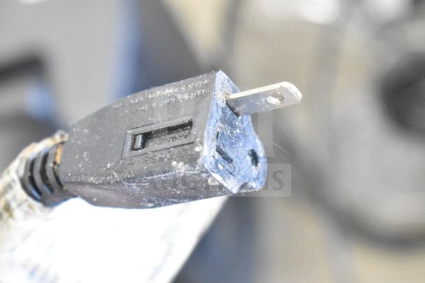 Alt text: Close-up of a worn plug for the Home Air SZPD-05 Fan. 120 Volts, 1 Phase, visible dirt and wear.