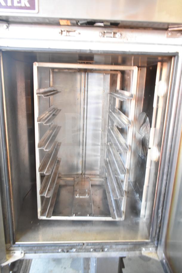 Baxter commercial gas-powered mini rotating rack oven with double pan rack, on commercial casters, stainless steel interior.