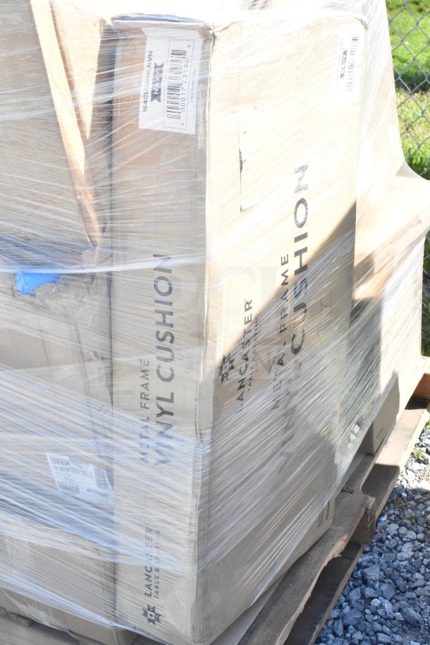 Pallet of wrapped boxes labeled "Lancaster Table Seating Metal Frame Vinyl Cushion." New scratch and dent items.