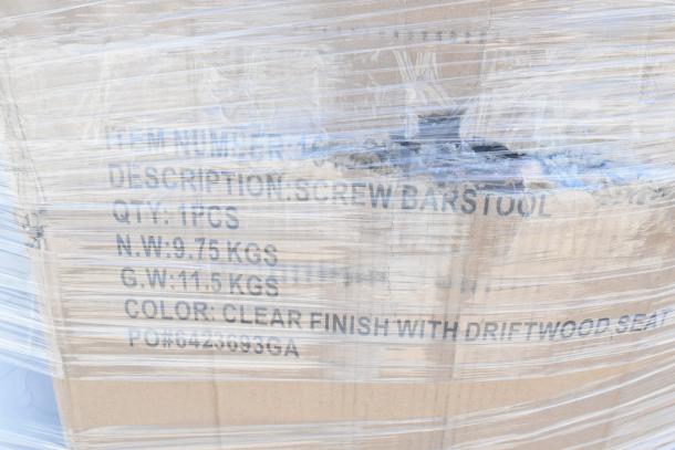 Cardboard box wrapped in plastic, labeled "Screw Barstool," 1 piece, 9.75 kg net weight, clear finish with driftwood seat.