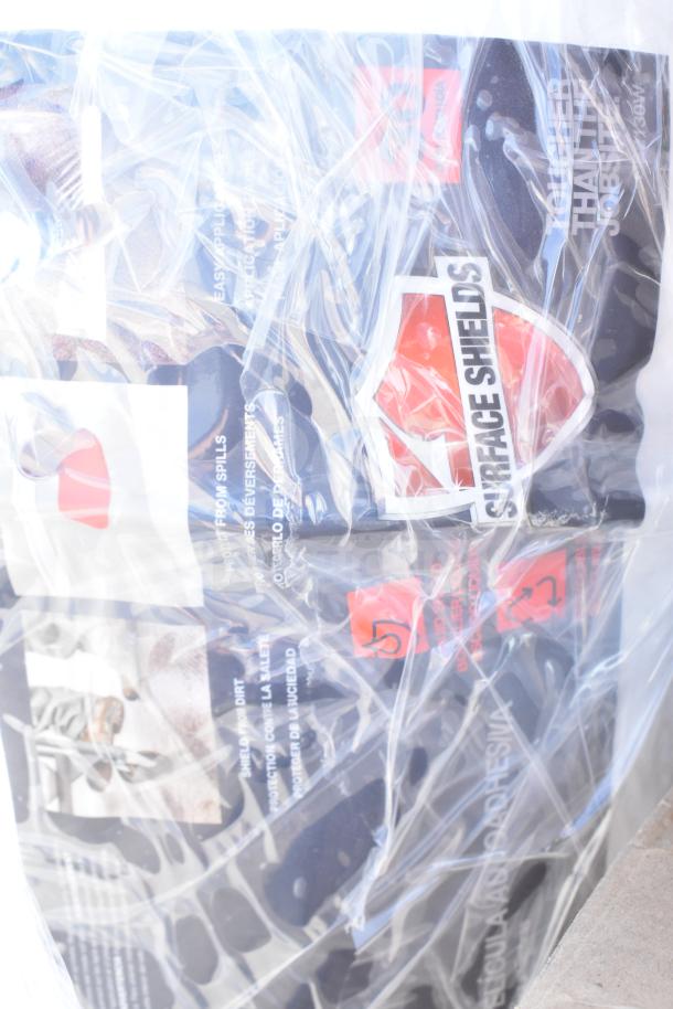 Packaged items with visible "Surface Shields" label, indicating new condition. Includes motor assembly, wok, and more. Plastic-wrapped.
