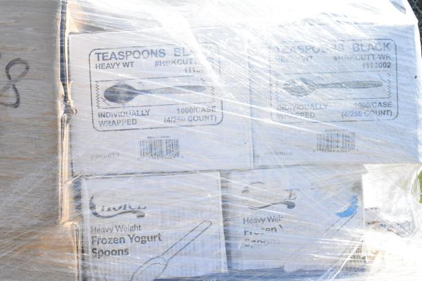 Palette of boxes wrapped in plastic, marked with "Teaspoons Black" and "Frozen Yogurt Spoons." Packaging indicates heavy weight and individual wrapping, 1000 per case.