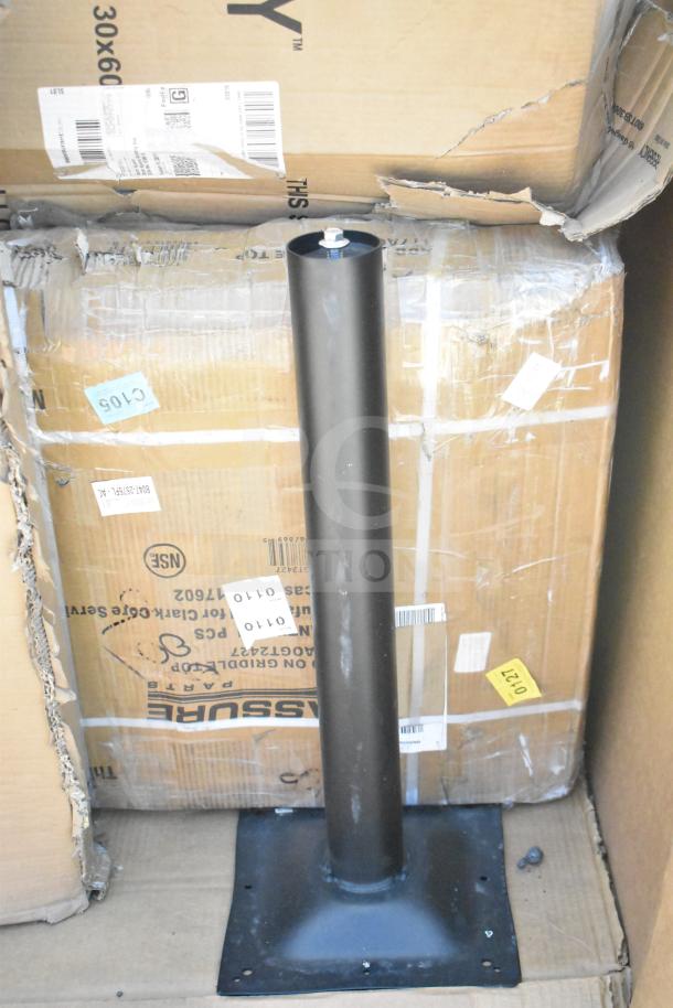 Black metal table leg amidst cardboard boxes with visible shipping labels. Brand new scratch and dent condition.
