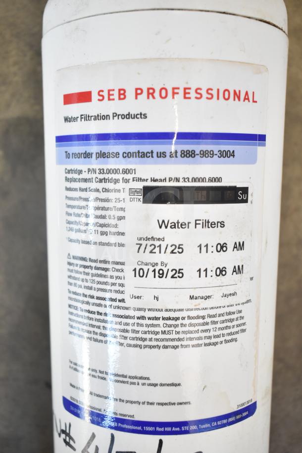 SEB Professional water filtration system, white cartridge P/N 33.0000.6001, label shows replacement info and contact number.