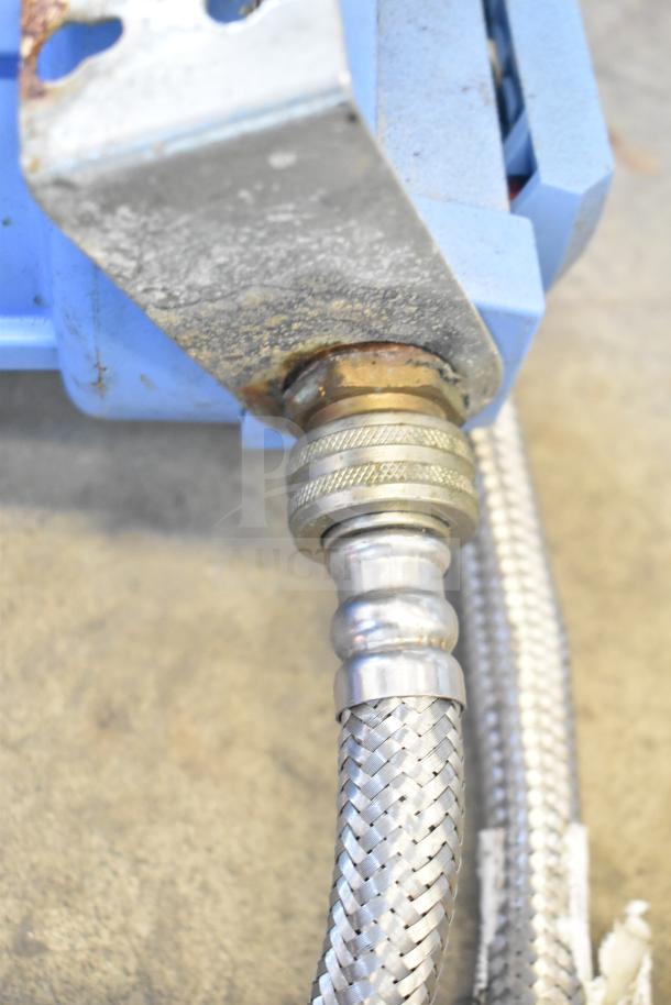 Water filtration system connection with metal braided hose, visible rust, and blue casing. Used condition indicated.