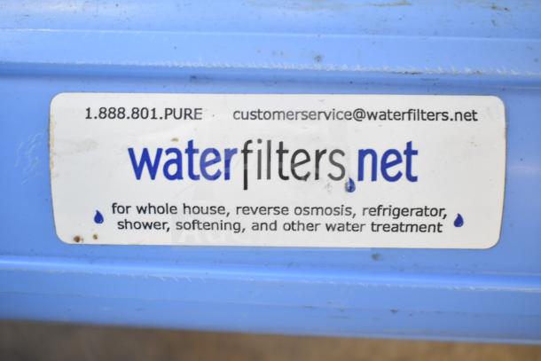 Blue water filtration system with "waterfilters.net" label for whole house, reverse osmosis, and other treatments.