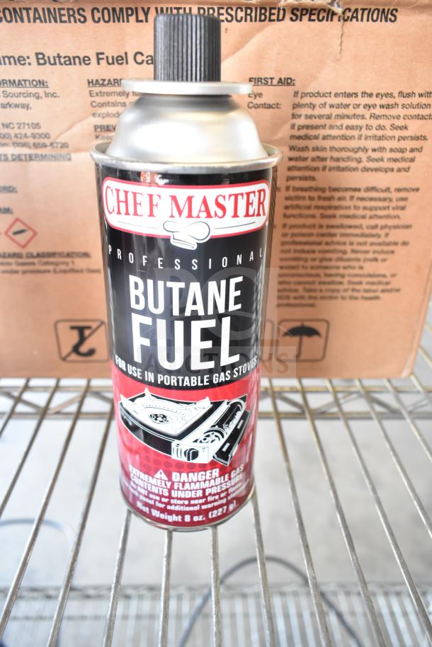 Chef Master Butane Fuel can next to a box labeled "Butane Fuel Cans." Both items in good condition for auction.