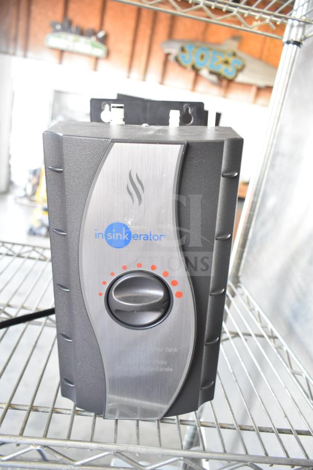 Insinkerator HWT Instant Hot Water Tank, 115 Volts, 1 Phase, black and stainless steel, on wire shelf.
