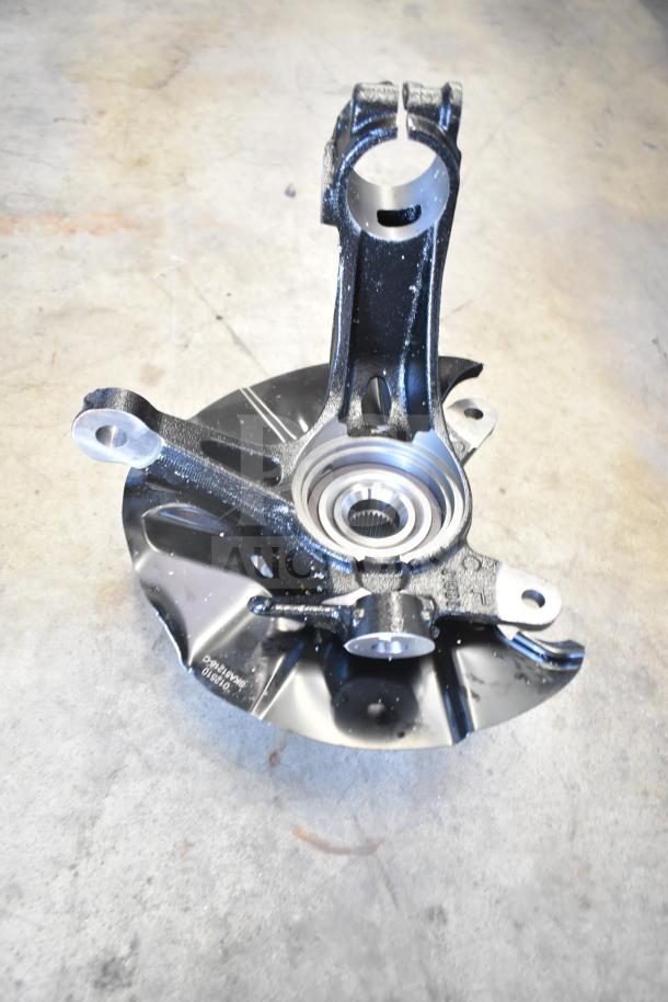 Lot of various mechanical items including a metal piece with a round opening, likely a bearing housing, in used condition.