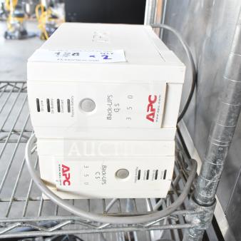 Two APC Back-UPS CS 350 units on a metal shelf, showing power and indicator labels. Slightly worn condition.
