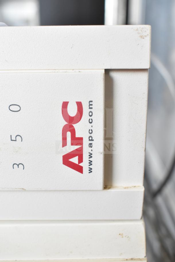 Two APC Back UPS CS 350 units, visible branding and model number. Slight wear, functional uninterruptible power supply.