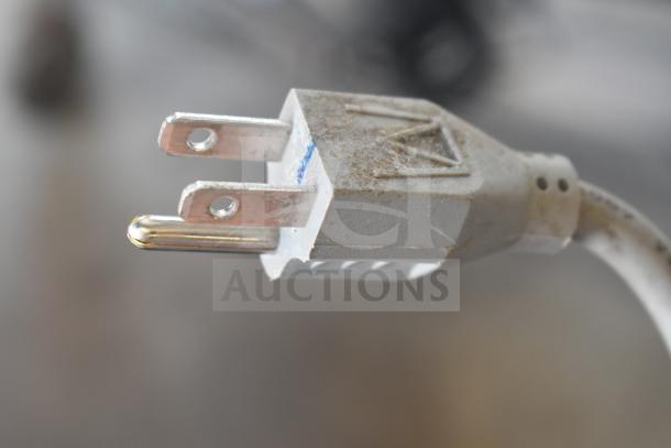 Power plug of APC Back UPS CS 350, showing slight wear, connected to uninterruptible power supply unit.