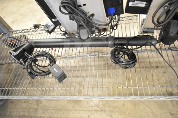 Two Acer monitors and NCR kitchen controller with cords on metal shelf, auction item in used condition.