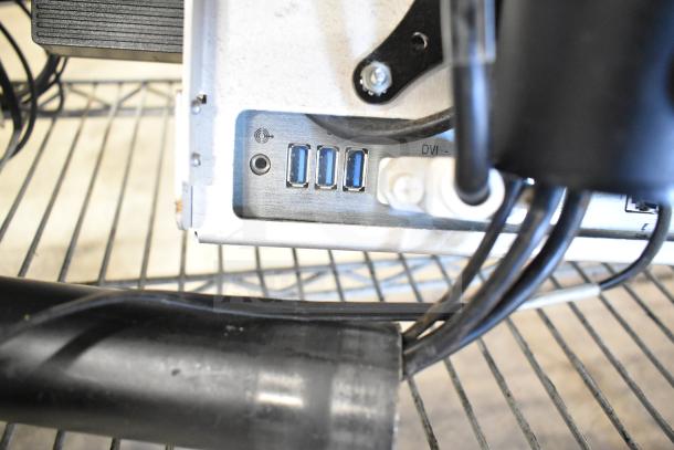 "Back panel of NCR Kitchen Controller, showing three USB ports and a DVI port, part of Acer monitor system."
