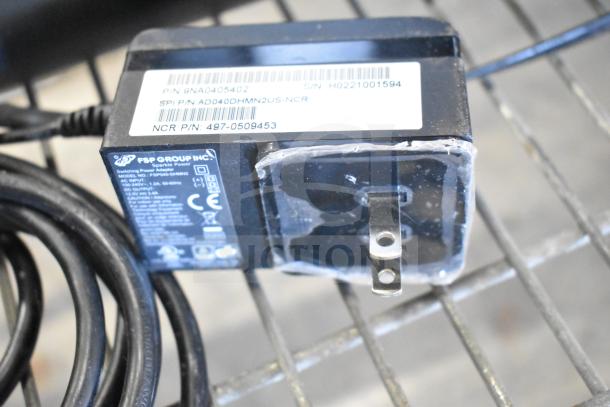 Power adapter of FSP Group, Inc. for NCR Kitchen Controller. Visible label with part numbers and specifications.