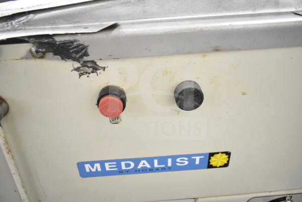 Medalist L20 commercial 20-quart dough mixer, visible metal wear, labeled "MEDALIST BY HOBART," features control knobs.