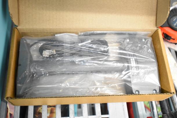 MX201-SI00WW Single Display, new in box, includes cables and mounting hardware, visible labels indicate serial number and compliance.