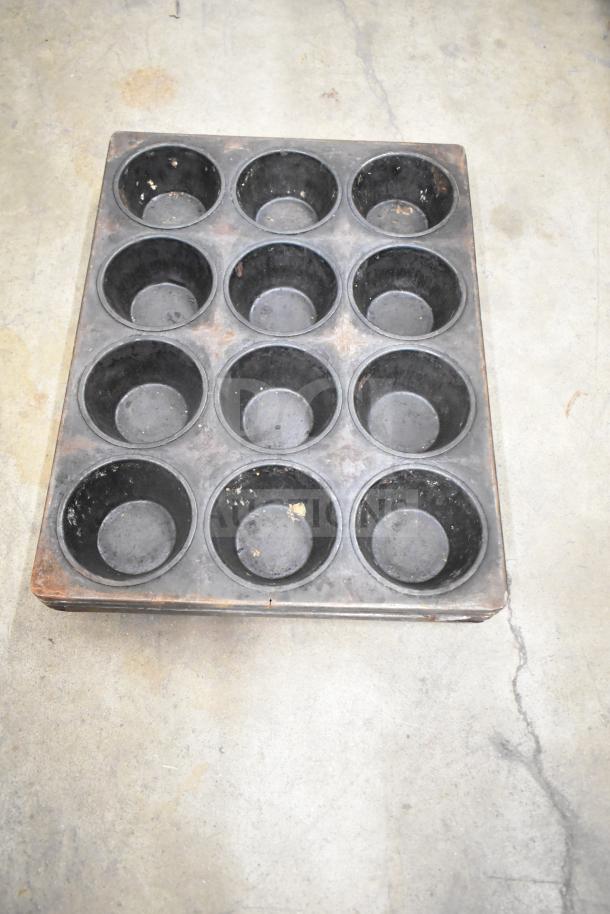 Auction item includes mesh and muffin baking pans. Twelve-cup muffin pan shown, used condition, minor wear visible.