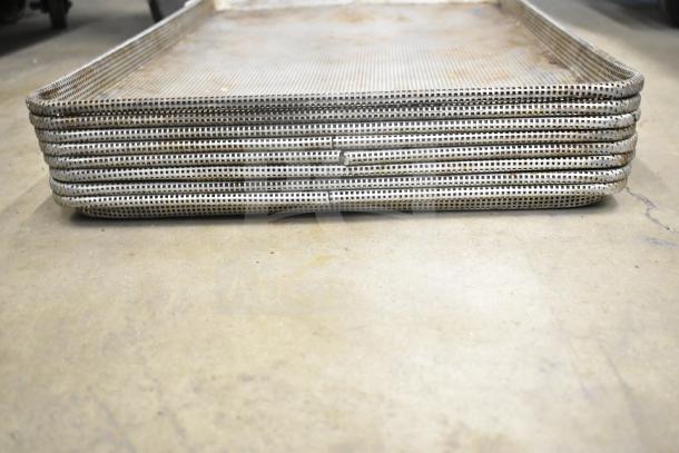 Stack of mesh baking pans showing signs of wear, part of a lot of 14 various kitchen items in auction.