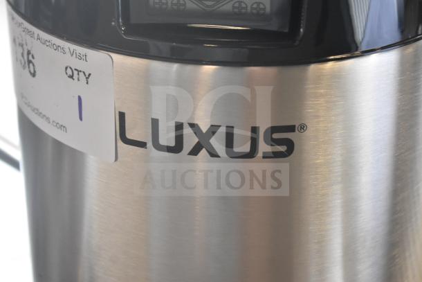 BRAND NEW Fetco L4D-15 Luxus 1.5 Gallon Stainless Steel Coffee Server, minor scratches, with stand, auction tag visible.