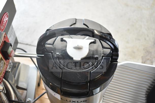BRAND NEW scratch and dent Fetco L4D-15 Luxus 1.5-gallon stainless steel coffee server with stand, visible top handle.