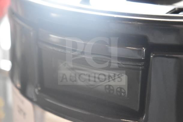 BRAND NEW SCRATCH AND DENT! Fetco L4D-15 Luxus 1.5 Gallon Stainless Steel Coffee Server with Stand, minor scratches visible.