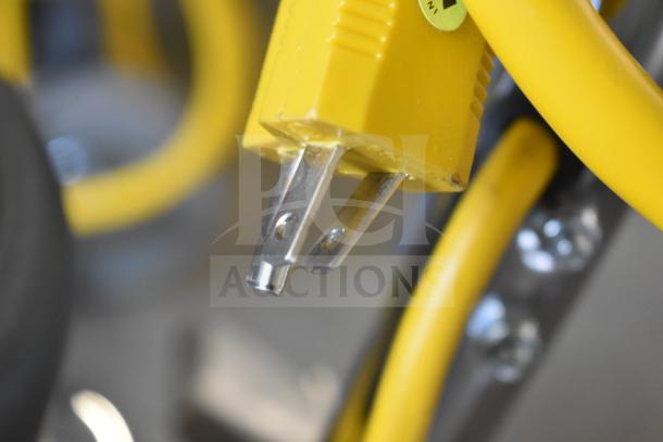Yellow power cord of Lavex Pro 978LPS20S floor machine, focus on plug; 20" heavy-duty, single speed, 175 RPM, 120V.