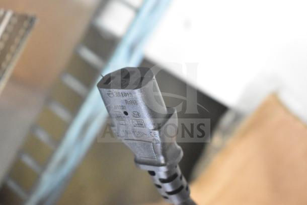 Close-up of a power cord plug with compliance markings for a Galaxy 177LT06A Food Dehydrator.