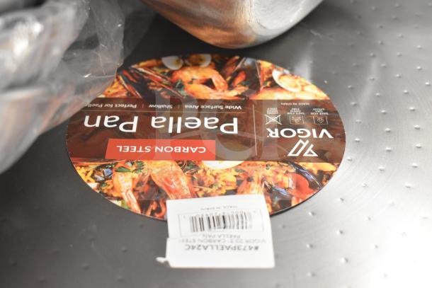 Vigor 24" Carbon Steel Paella Pan with label; brand new condition, suitable for shallow cooking, made in Spain.