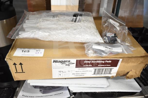 Box with Niagara Deep Scrubbing Pads, white mop heads, and labeled circuit breaker, indicating quantity and size for auction.