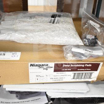Box with Niagara Deep Scrubbing Pads, white mop heads, and labeled circuit breaker, indicating quantity and size for auction.