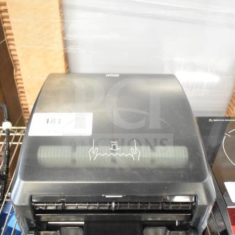 BRAND NEW Tork 772728 black mechanical paper towel dispenser with minor scratches and dents, model H71, retail tag visible.