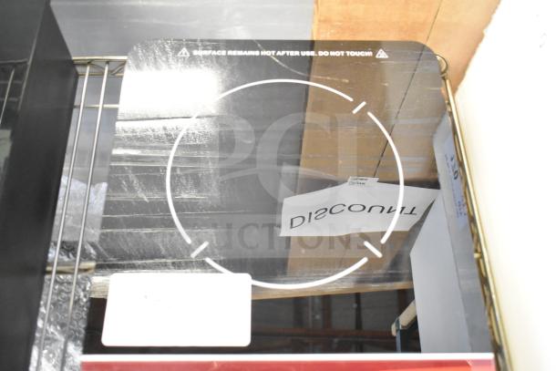 BRAND NEW Avantco 177ICBTM20 induction range, countertop model, 120V, 1 phase, slight scratch and dent, visible "Do Not Touch" warning.