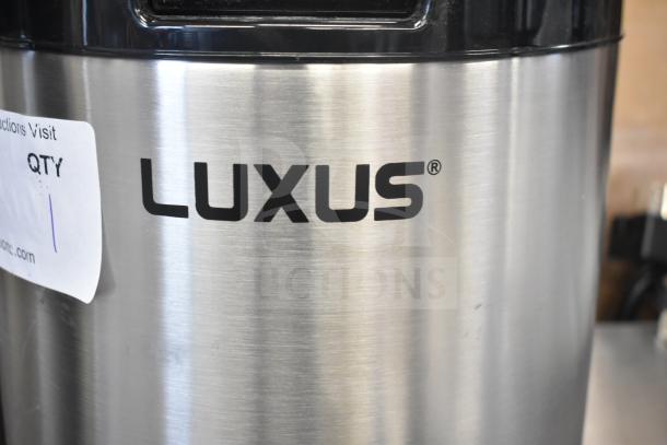 alt text: Fetco L4D-20 Luxus 2 Gallon Stainless Steel Coffee Server. Slight scratches visible, marked "LUXUS." New condition.
