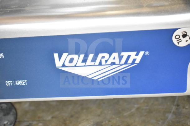 "Vollrath 40955 SLP330E/S Meat Slicer close-up showing logo. Brand new, scratch and dent condition, 1/2 hp, 120V."