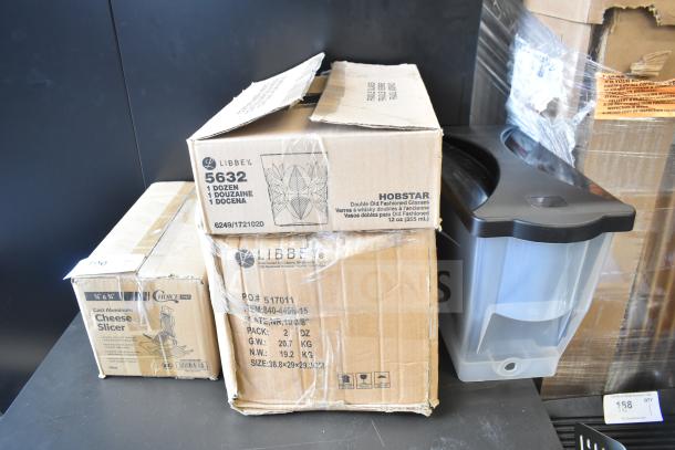 Four boxed items, including Choice CHEESECMB cheese slicer, Libbey 10 3/8" porcelain plates, Hobstar 12 oz. glasses, and Choice beverage dispenser.