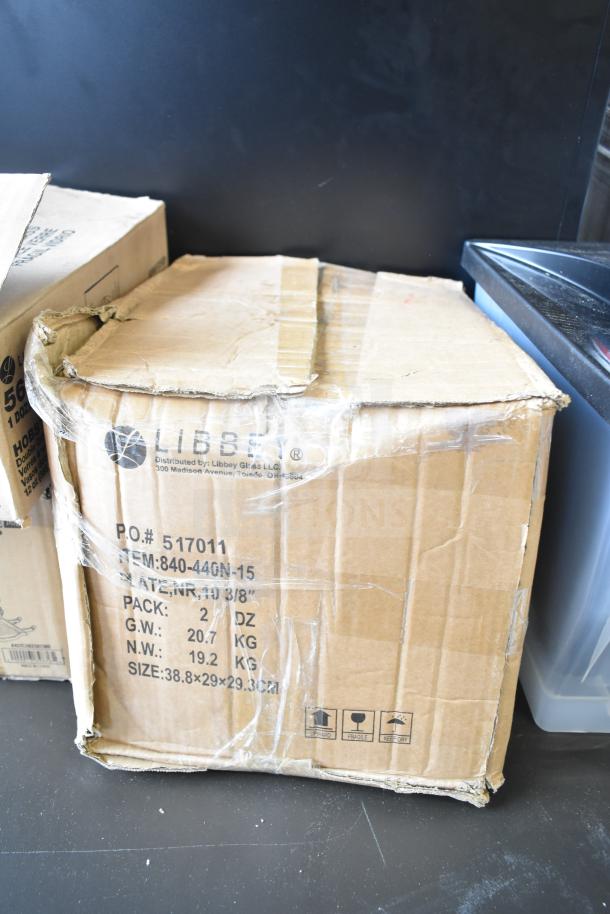 Cardboard box labeled Libbey 840-440N-15 Porcelana plates, slightly damaged, sealed with tape, showing shipping details.